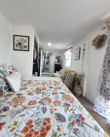 a bedroom with bed and a couch