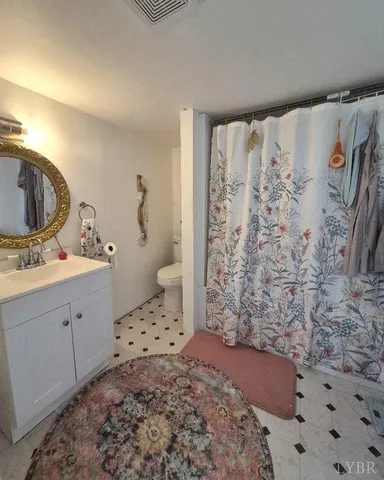 a view of a yard with plants and a tree