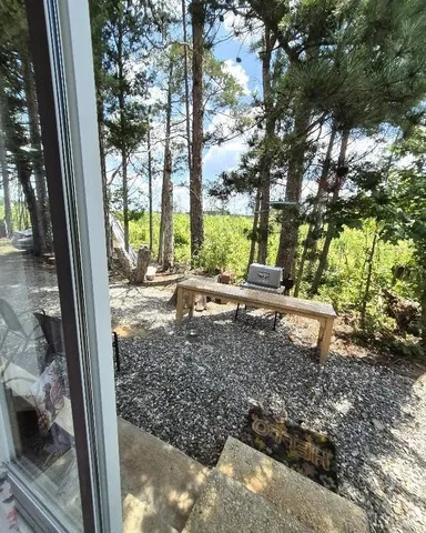 a backyard of a house with table and chairs