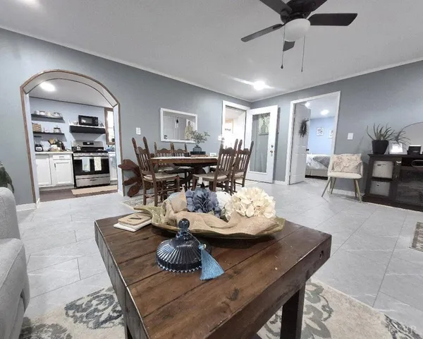 a living room with furniture and wooden floor