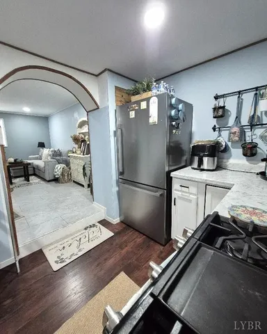 a kitchen with stainless steel appliances granite countertop a refrigerator stove and sink
