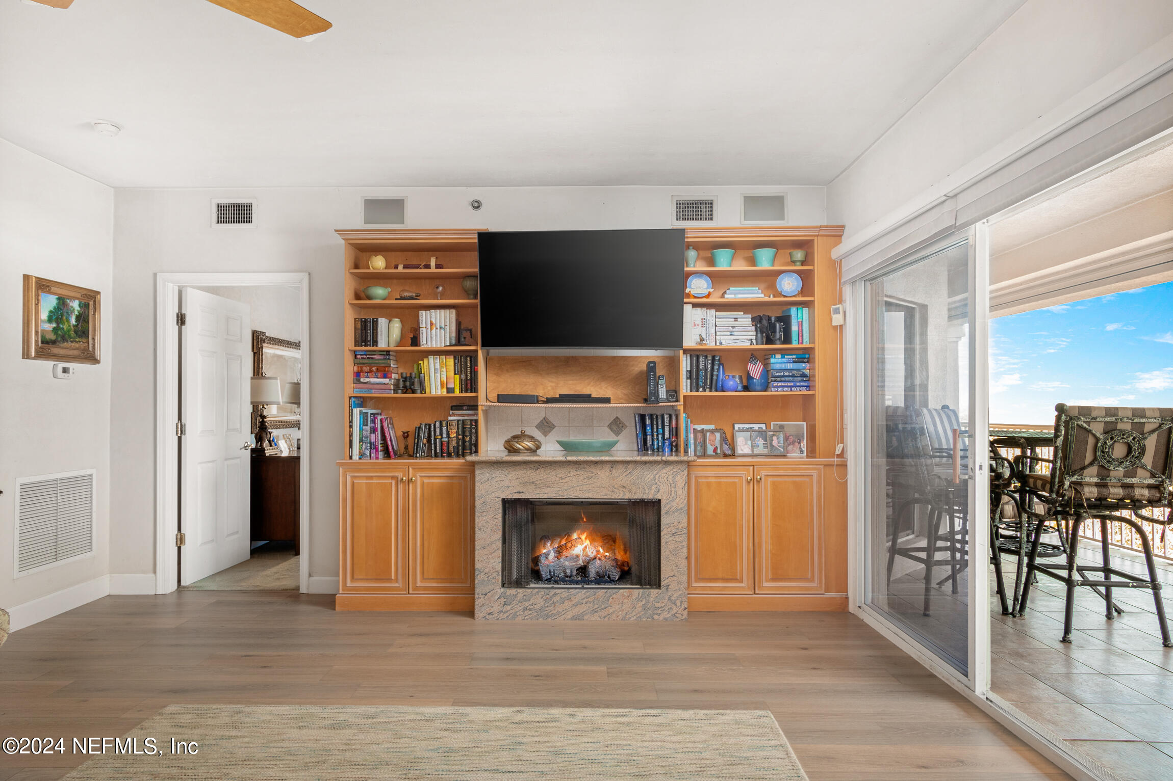 7790 A1A South, Unit 101 St. Augustine, FL 32080 - Photo 11 of 79 a living room with stainless steel appliances furniture a fireplace and a window