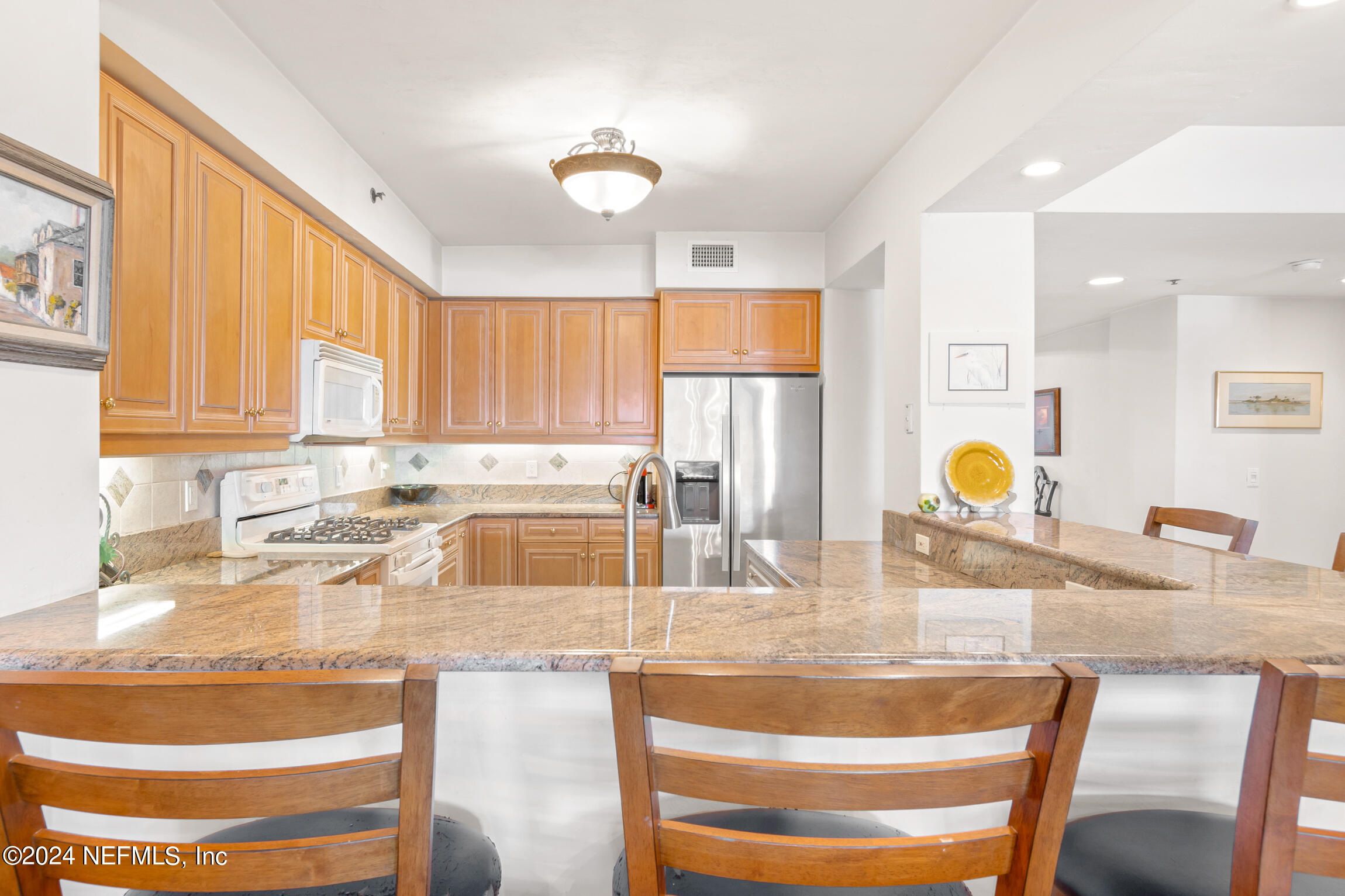 7790 A1A South, Unit 101 St. Augustine, FL 32080 - Photo 16 of 79 a kitchen with granite countertop a sink and a cabinets
