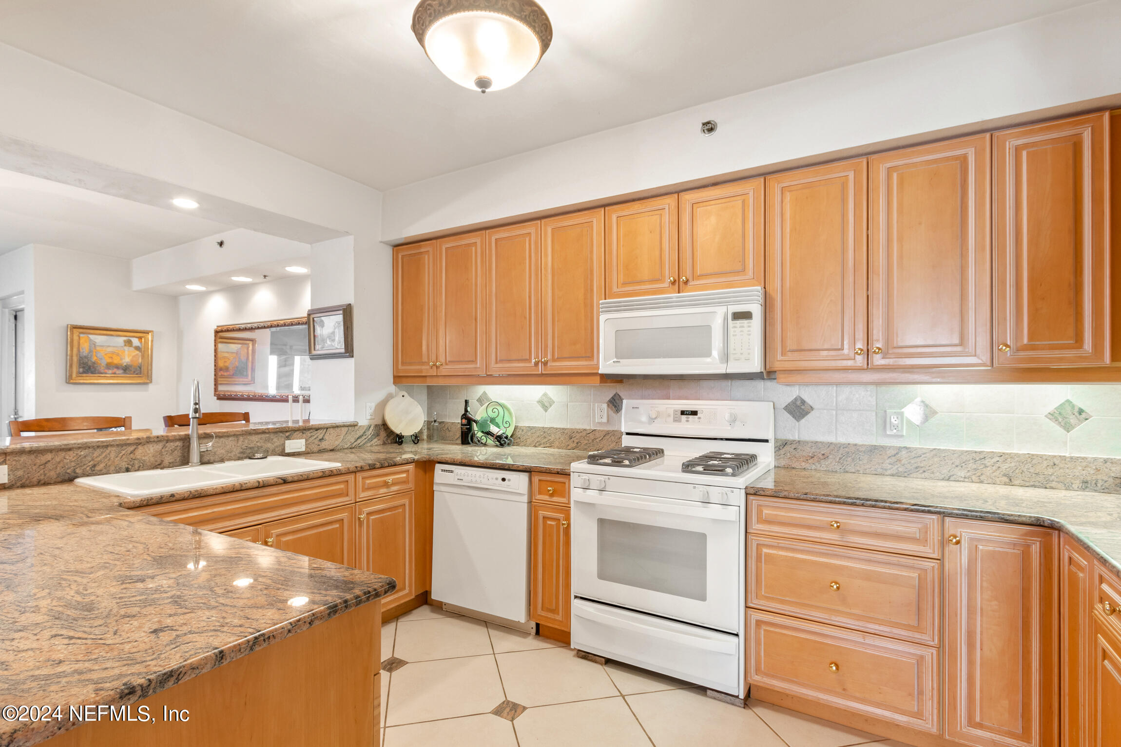 7790 A1A South, Unit 101 St. Augustine, FL 32080 - Photo 17 of 79 a kitchen with stainless steel appliances granite countertop a stove a sink and a refrigerator