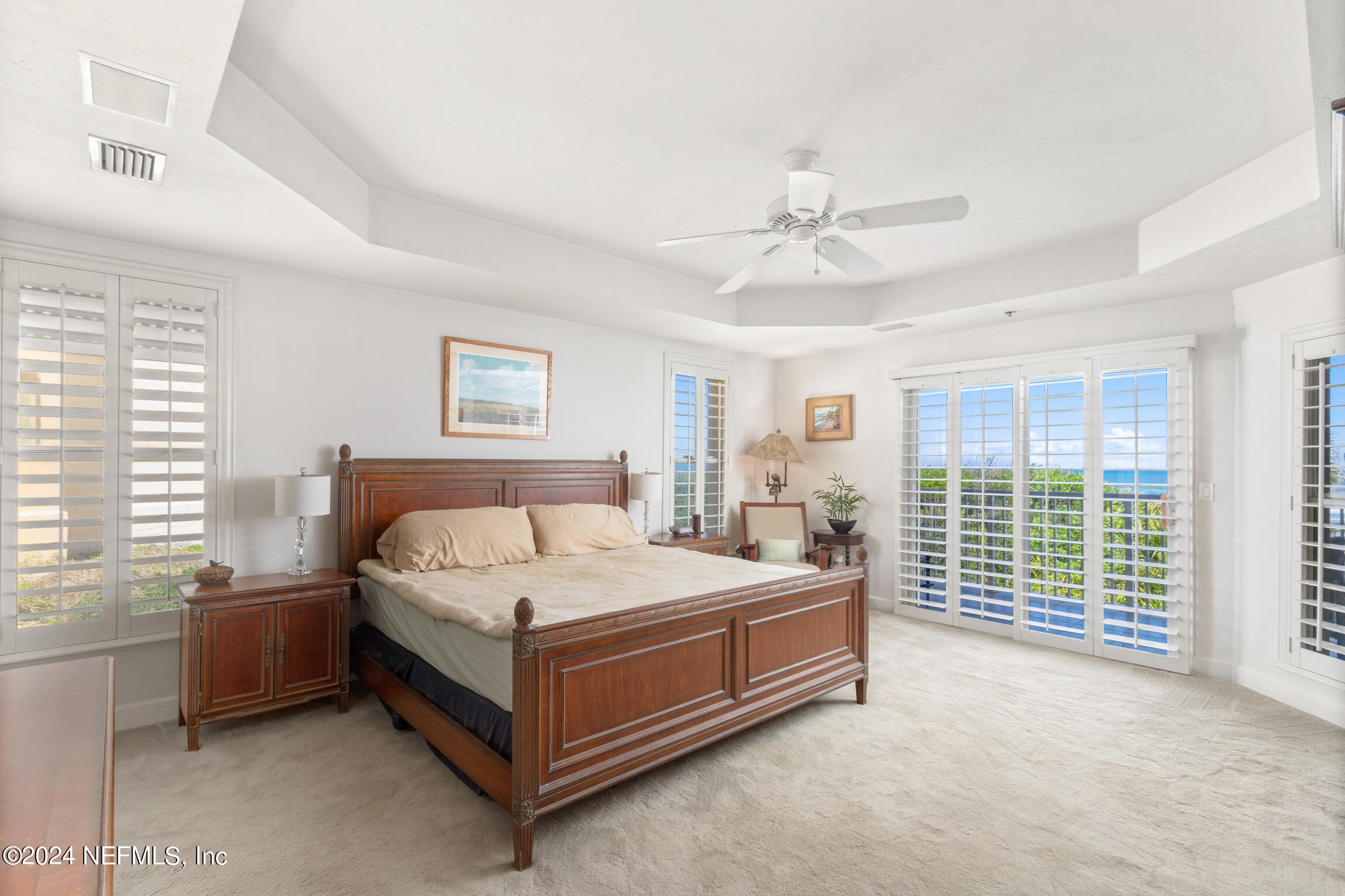 7790 A1A South, Unit 101 St. Augustine, FL 32080 - Photo 20 of 79 a bed sitting in a spacious bedroom next to a window