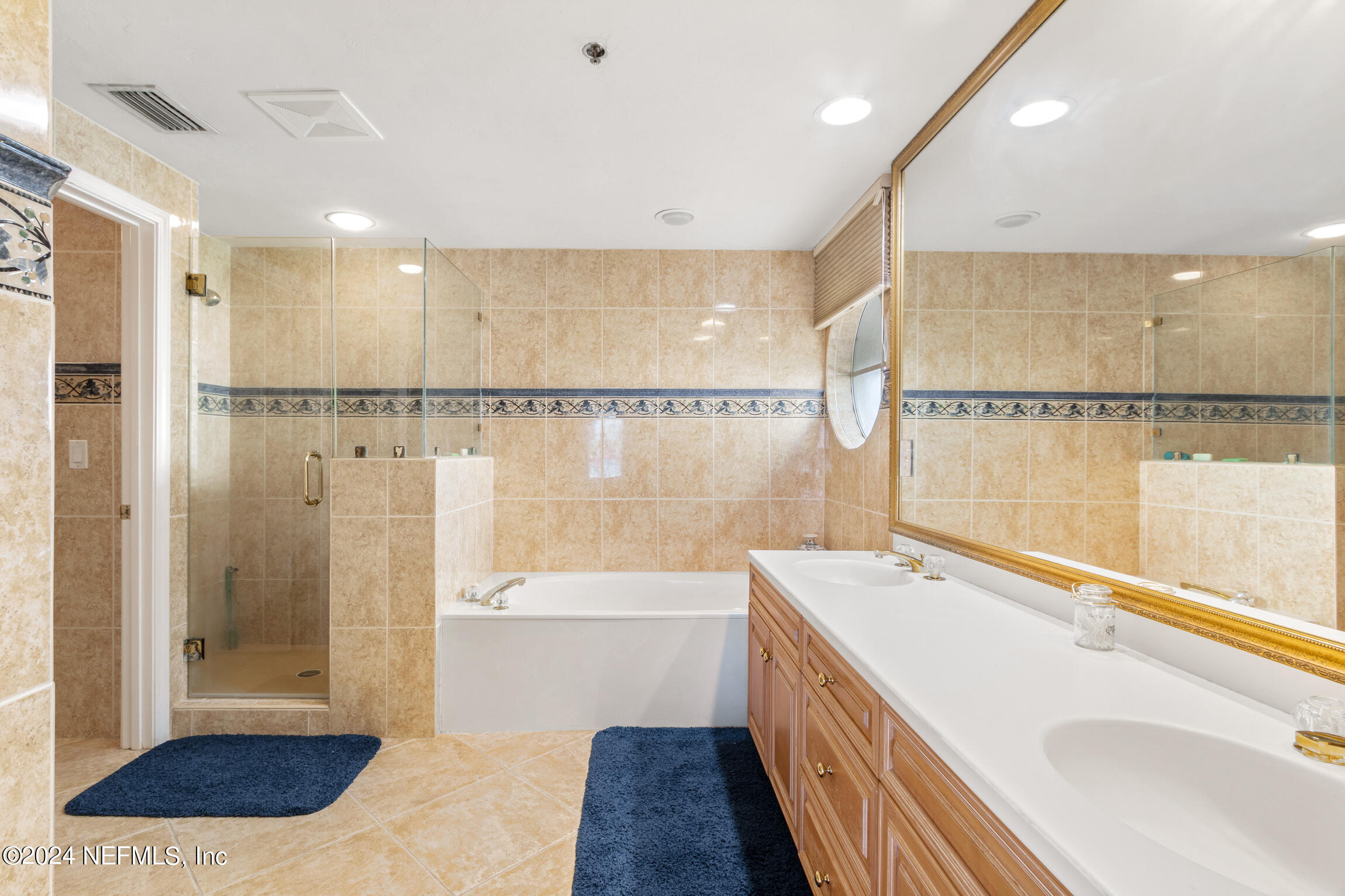 7790 A1A South, Unit 101 St. Augustine, FL 32080 - Photo 23 of 79 a bathroom with a tub a sink and a shower