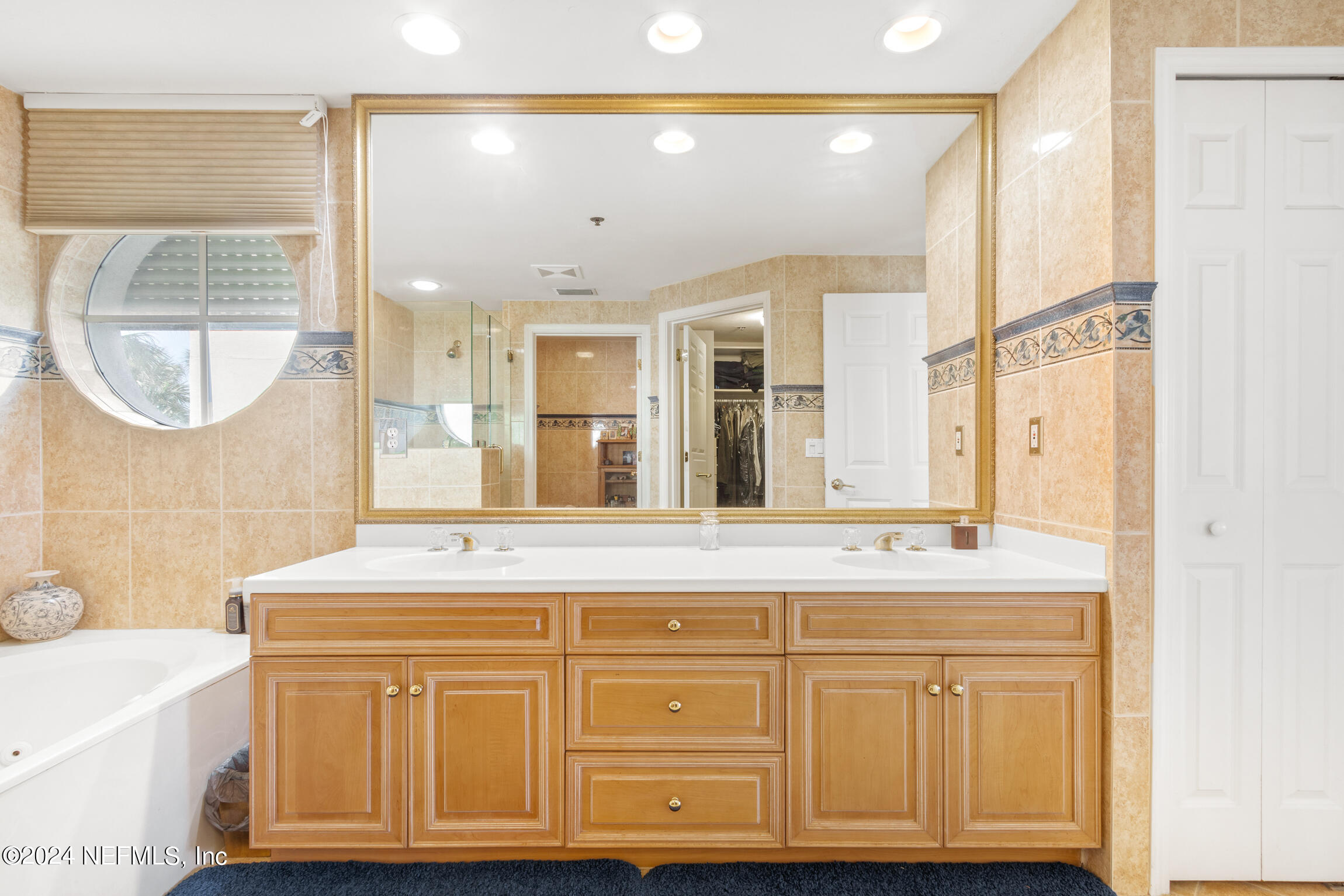 7790 A1A South, Unit 101 St. Augustine, FL 32080 - Photo 24 of 79 a bathroom with a sink vanity and mirror
