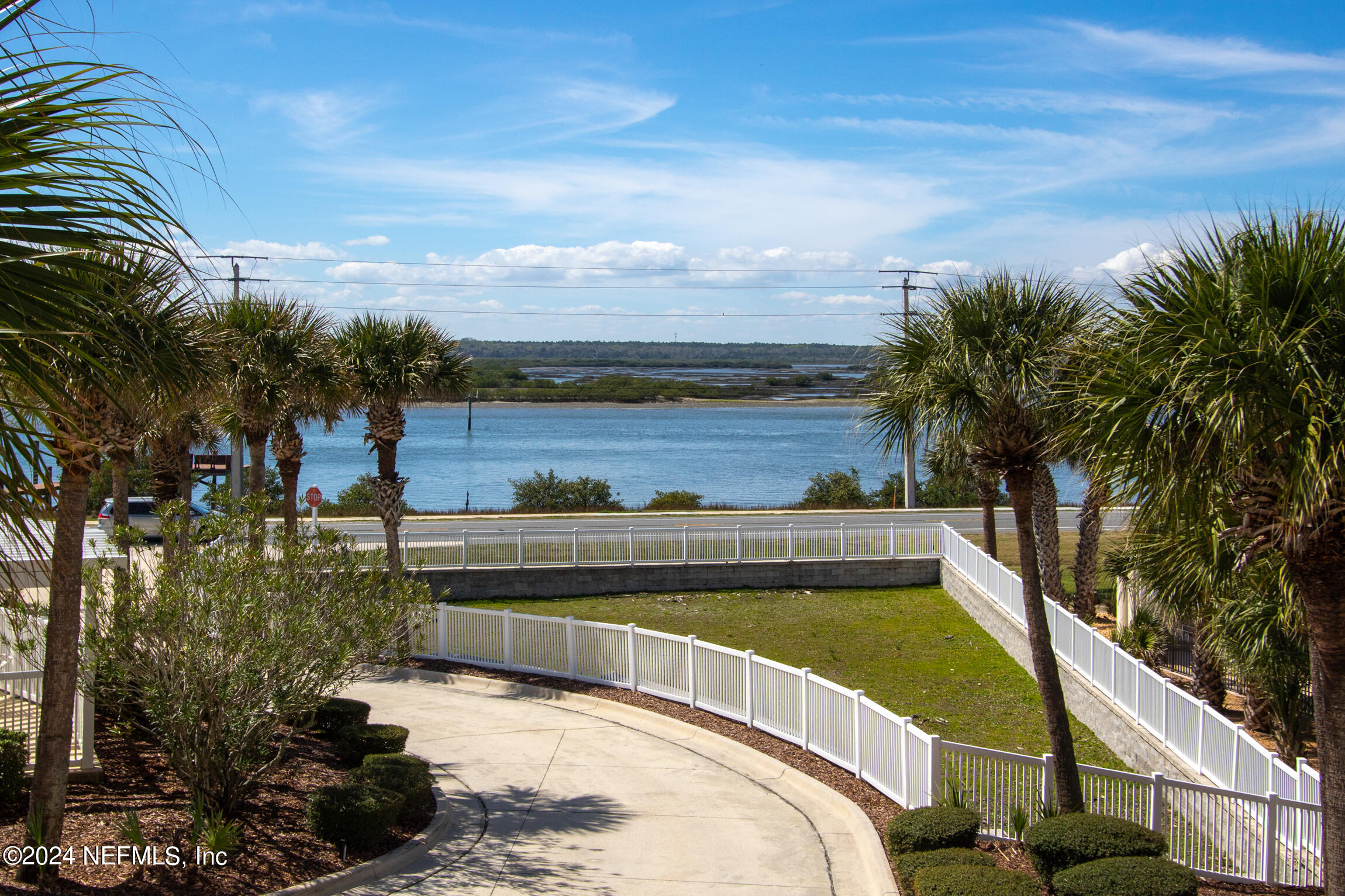7790 A1A South, Unit 101 St. Augustine, FL 32080 - Photo 30 of 79 a view of a swimming pool with a lawn chairs under an umbrella