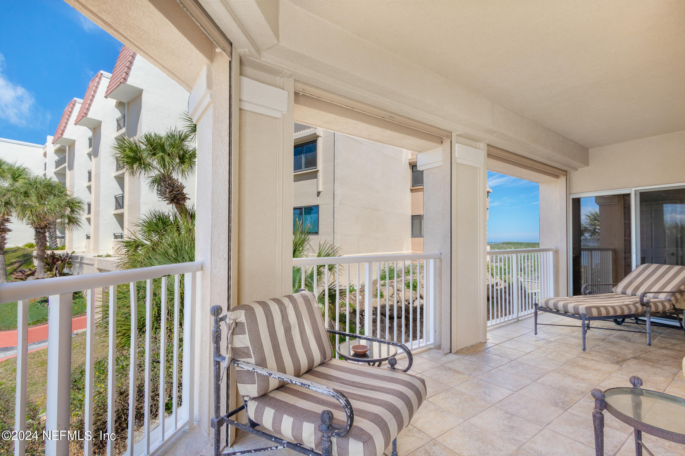7790 A1A South, Unit 101 St. Augustine, FL 32080 - Photo 31 of 79 a view of a balcony with two chairs and a chair