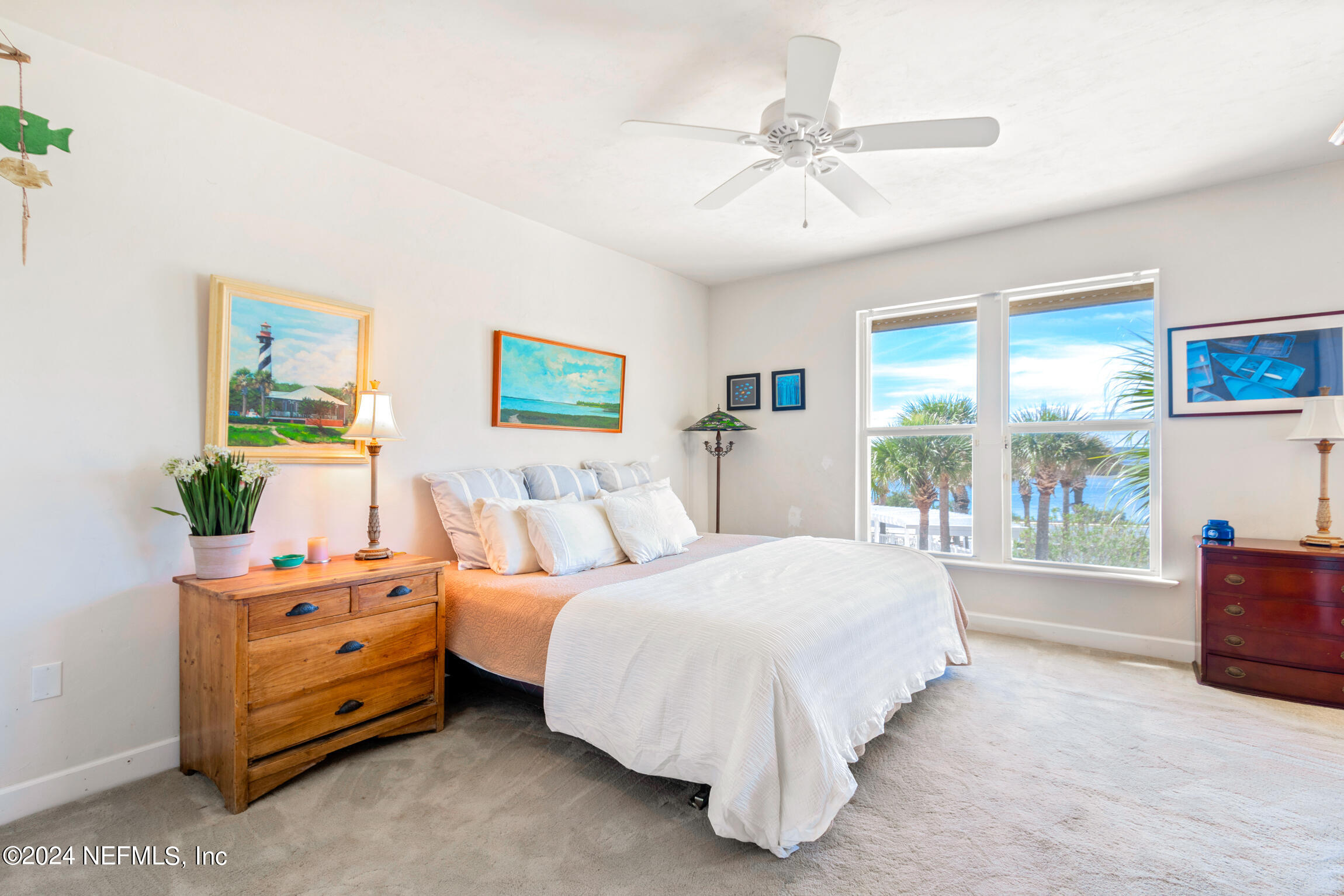 7790 A1A South, Unit 101 St. Augustine, FL 32080 - Photo 38 of 79 a bedroom with a bed a large window with table and chair