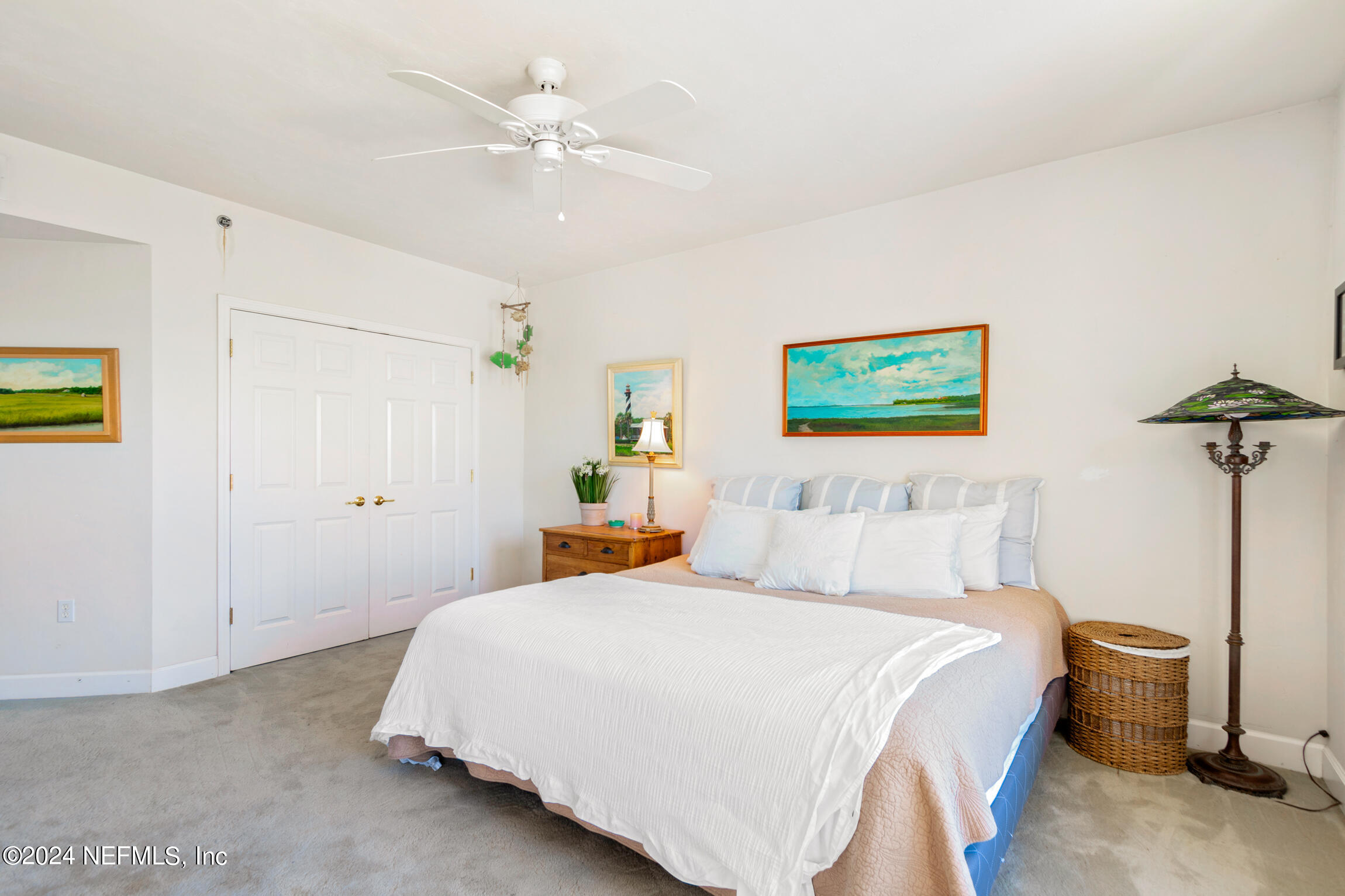 7790 A1A South, Unit 101 St. Augustine, FL 32080 - Photo 39 of 79 a bedroom with a bed and a chandelier