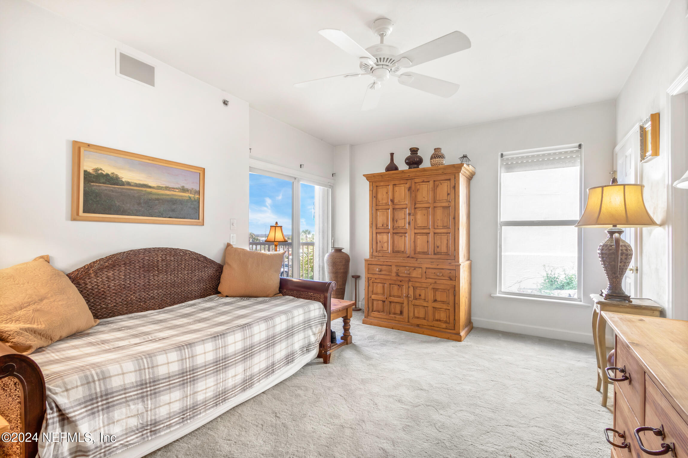 7790 A1A South, Unit 101 St. Augustine, FL 32080 - Photo 41 of 79 a bedroom with a bed a dresser and next to a window