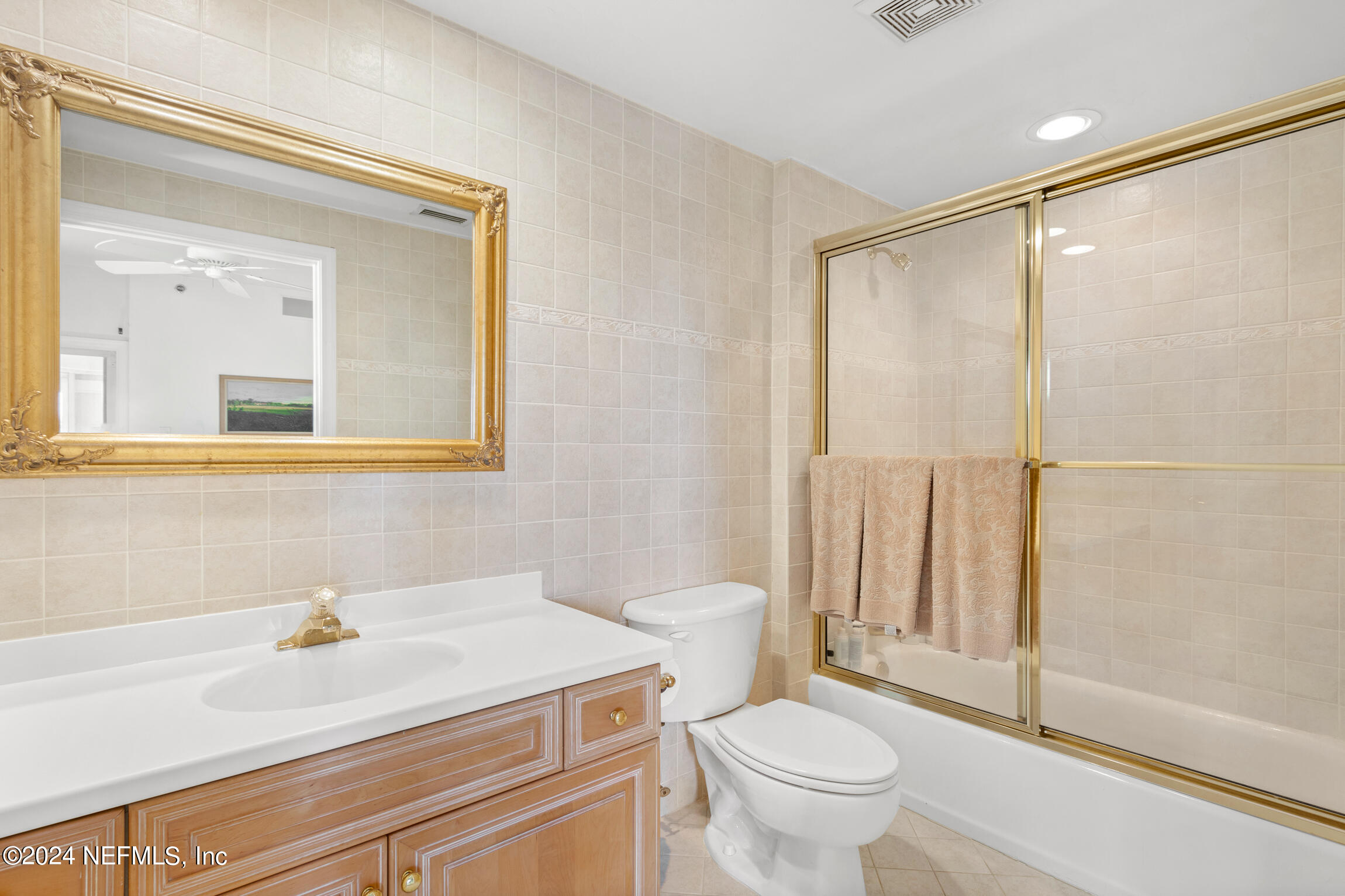 7790 A1A South, Unit 101 St. Augustine, FL 32080 - Photo 43 of 79 a bathroom with a sink a toilet and a mirror