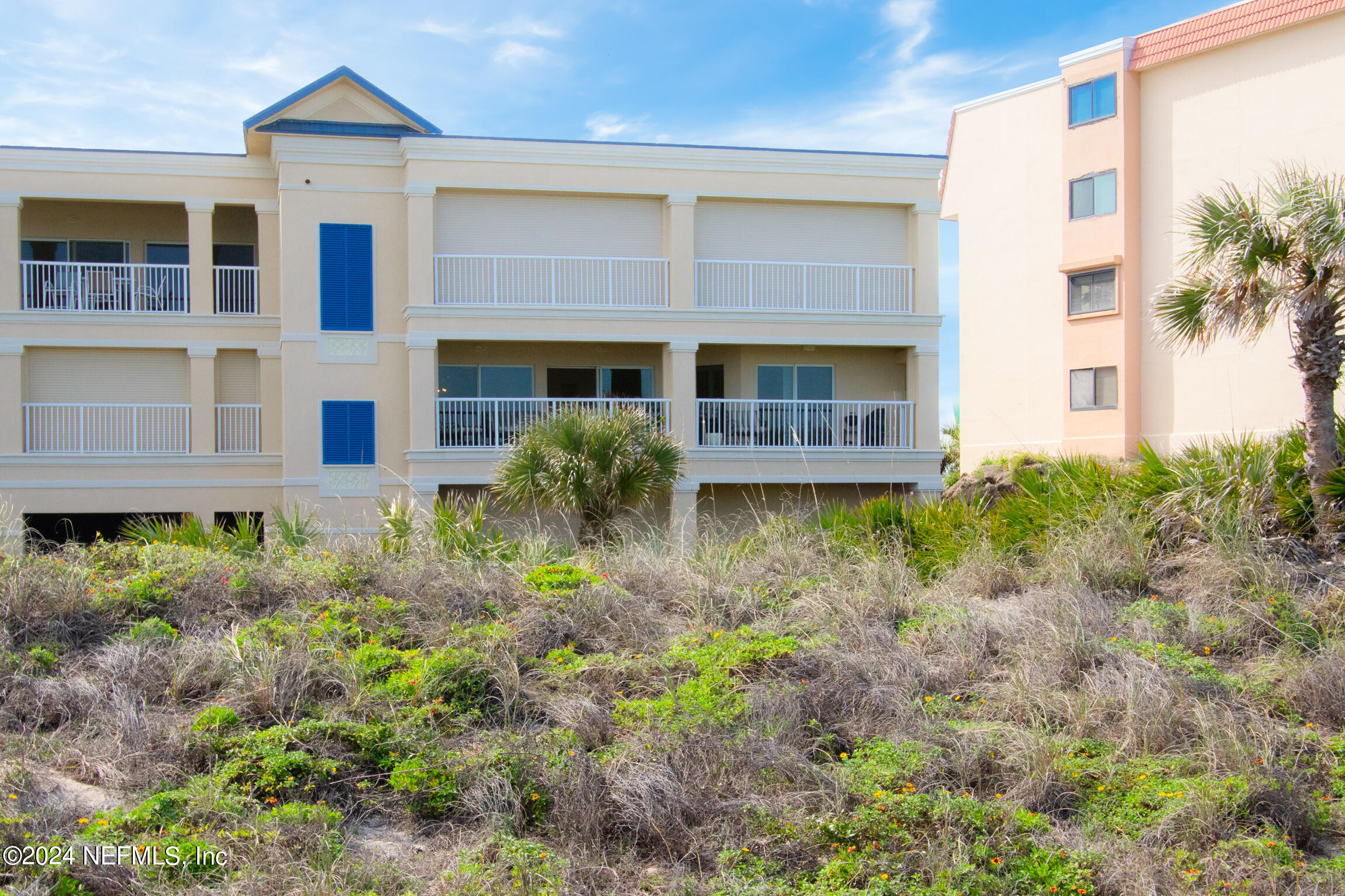 7790 A1A South, Unit 101 St. Augustine, FL 32080 - Photo 47 of 79 a front view of a house with garden