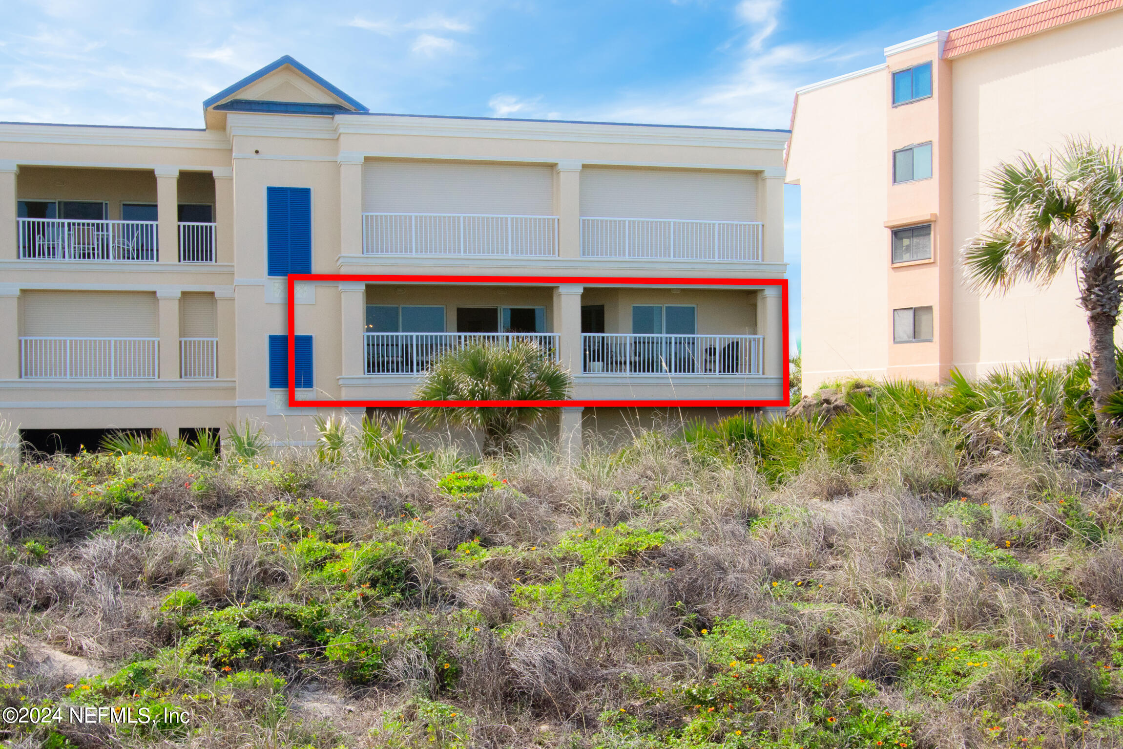 7790 A1A South, Unit 101 St. Augustine, FL 32080 - Photo 48 of 79 a view of a brick house with large windows and a yard