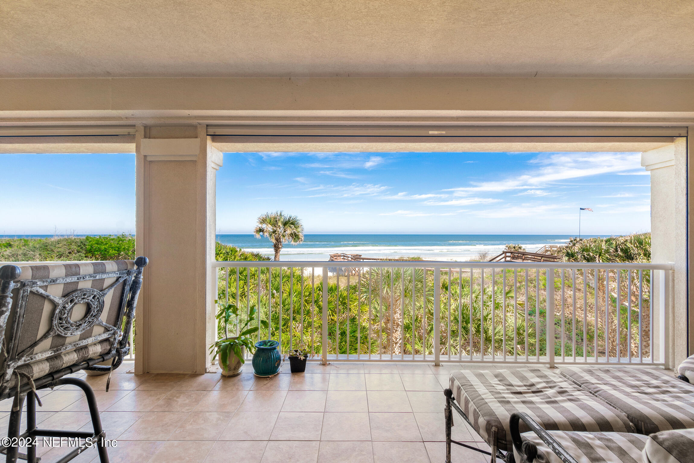 7790 A1A South, Unit 101 St. Augustine, FL 32080 - Photo 5 of 79 a living room with furniture and a floor to ceiling window