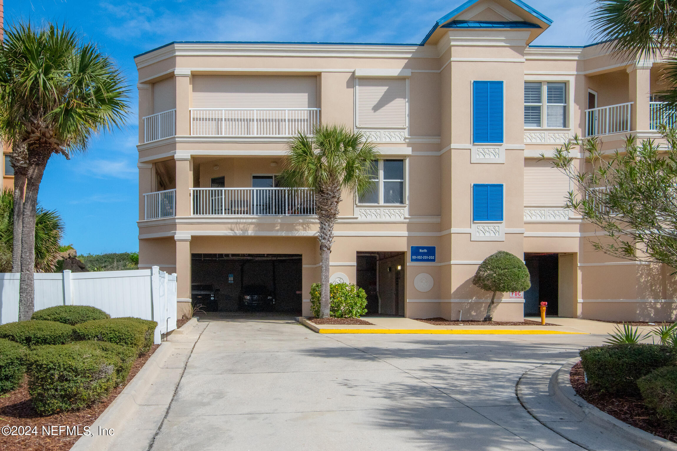 7790 A1A South, Unit 101 St. Augustine, FL 32080 - Photo 53 of 79 a front view of a house with a yard and garage
