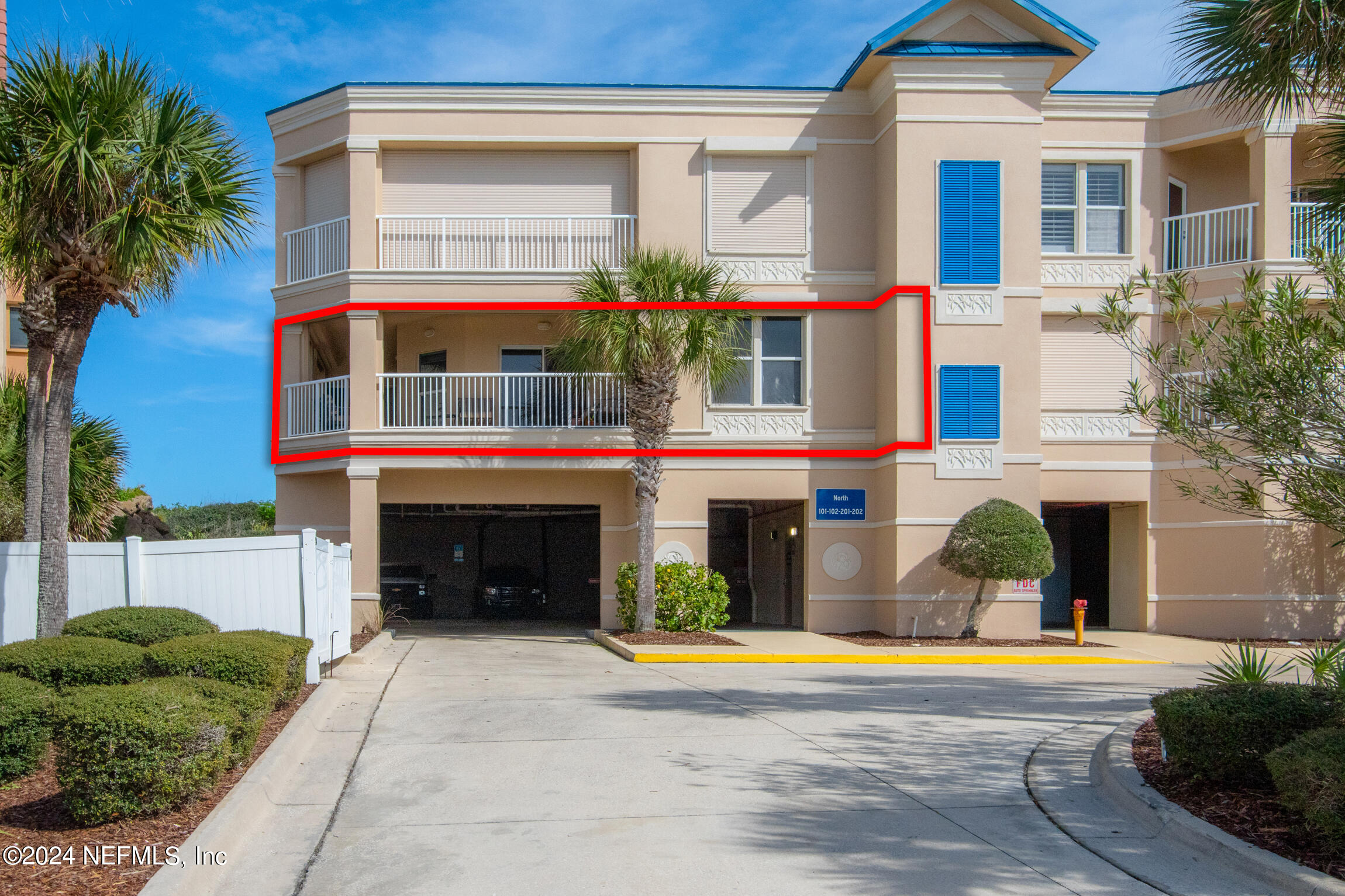 7790 A1A South, Unit 101 St. Augustine, FL 32080 - Photo 54 of 79 a front view of a house with a yard and garage