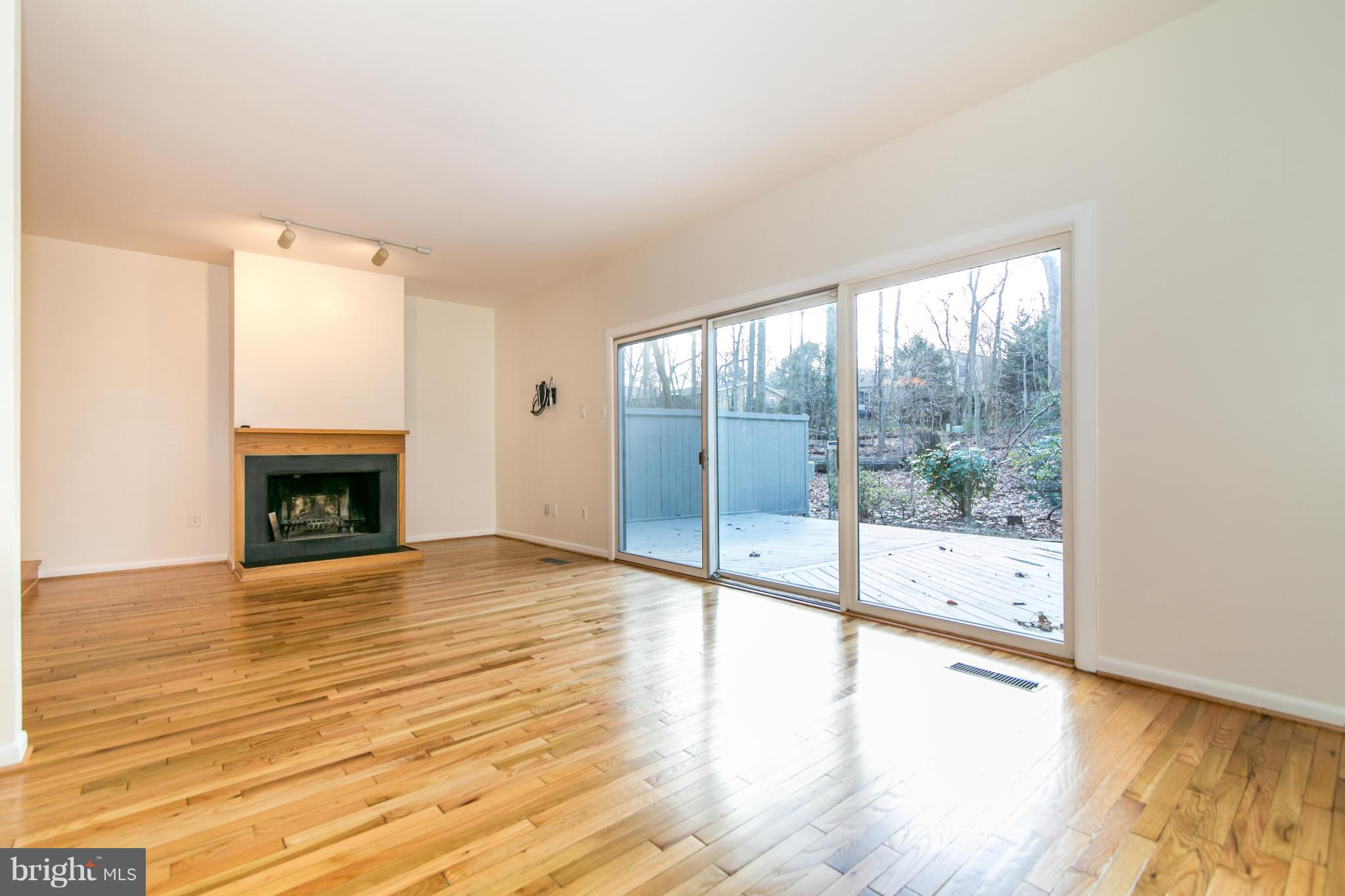 12017 Insha Court Reston, VA 20191 - Photo 8 of 30 The living room has a large, Pella sliding door.