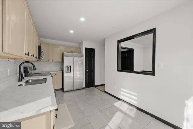 a kitchen with stainless steel appliances granite countertop a refrigerator sink and stove