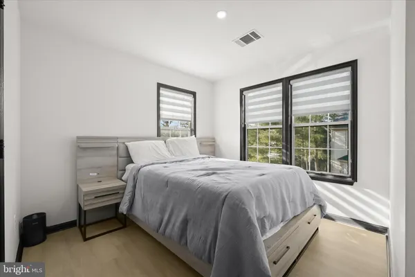 a spacious bedroom with a bed and a large window