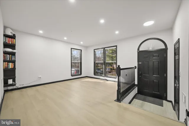 a view of empty room with floor to ceiling window and glass door