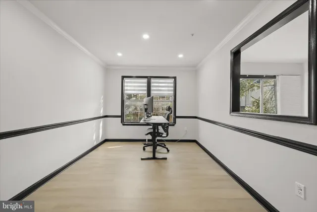 a view of a room with gym equipment and a large window