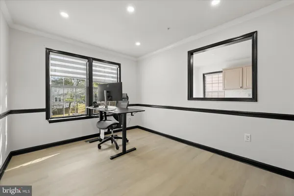 a view of a workspace with furniture and a window