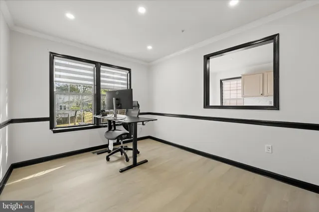 a view of a workspace with furniture and a window