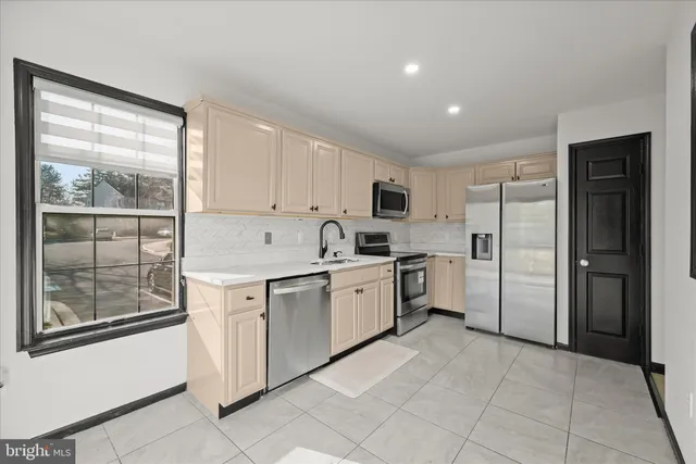 a kitchen with white cabinets and white appliances