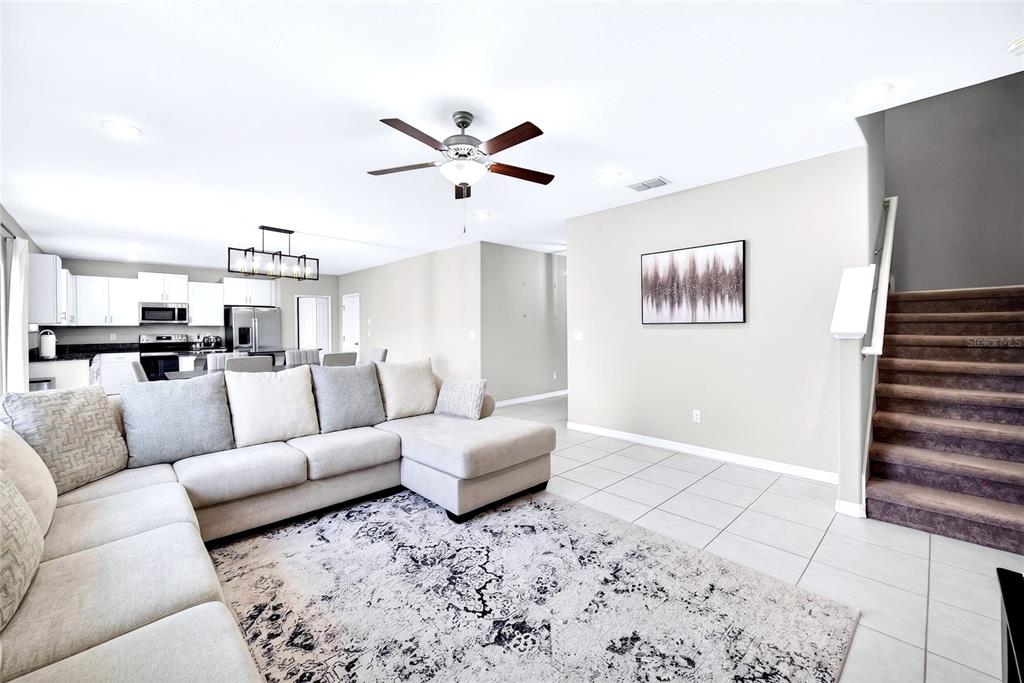 31724 Sun Kettle Loop Wesley Chapel, FL 33545 - Photo 3 of 49 a living room with furniture and kitchen view