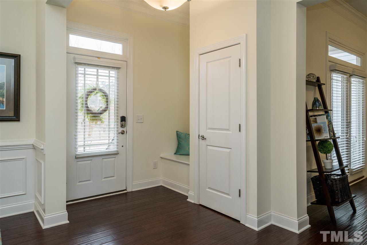 5616 Wade Park Boulevard Raleigh, NC 27607 - Photo 3 of 30 Walk in to beautiful hardwoods, a built in bench and coat closet.