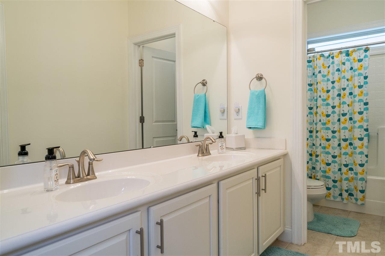 5616 Wade Park Boulevard Raleigh, NC 27607 - Photo 22 of 30 Secondary bathroom on second level of home with double sinks and ample storage below plus a closet!