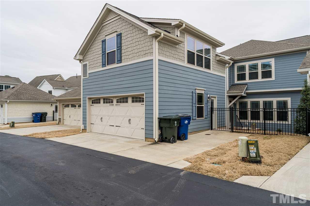 5616 Wade Park Boulevard Raleigh, NC 27607 - Photo 28 of 30 Rear view of home showing parking pad, 2 car garage, and exterior view of suite over garage!