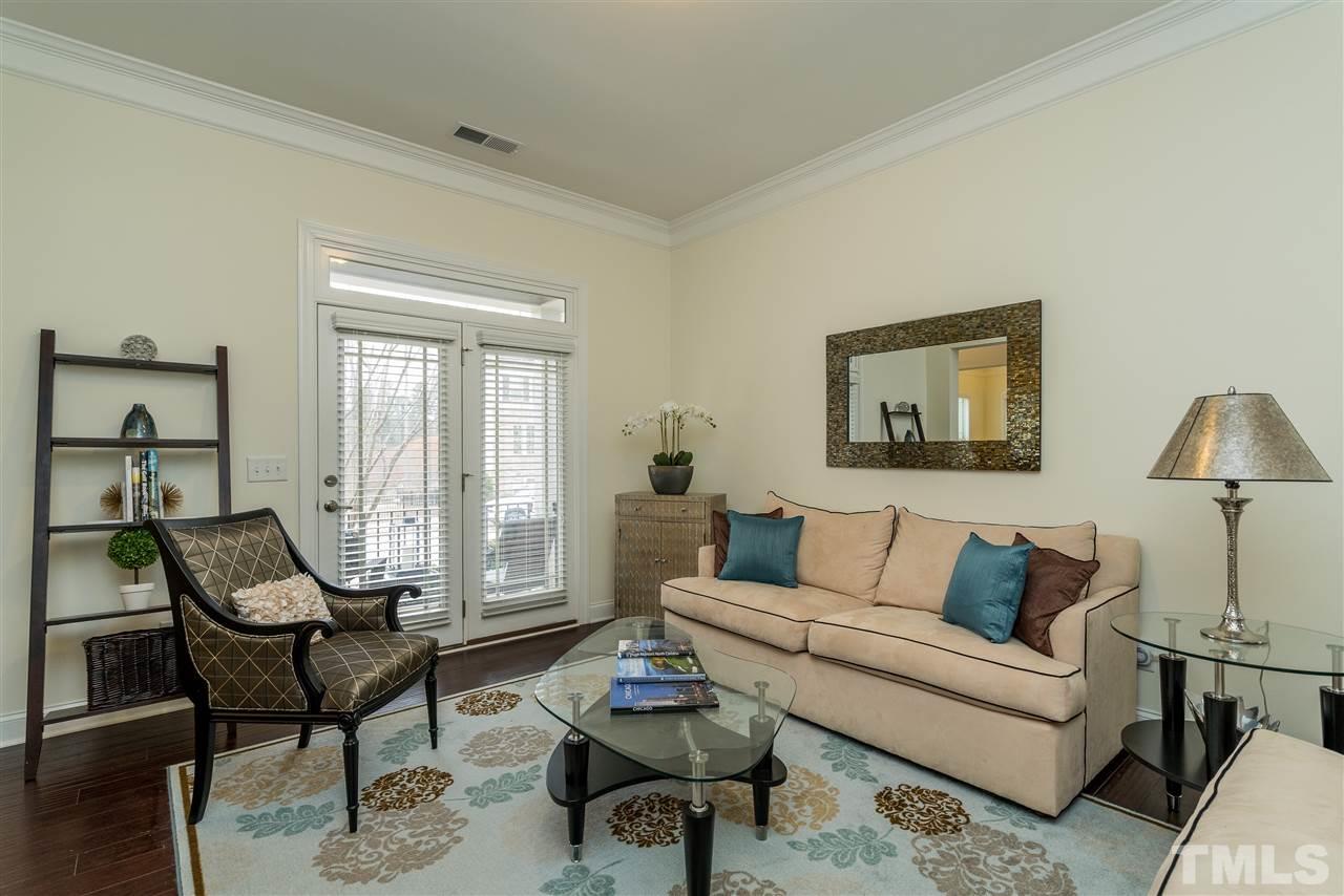5616 Wade Park Boulevard Raleigh, NC 27607 - Photo 4 of 30 Living room on main level across from the dining room! Enjoy access to the front porch from this room too.