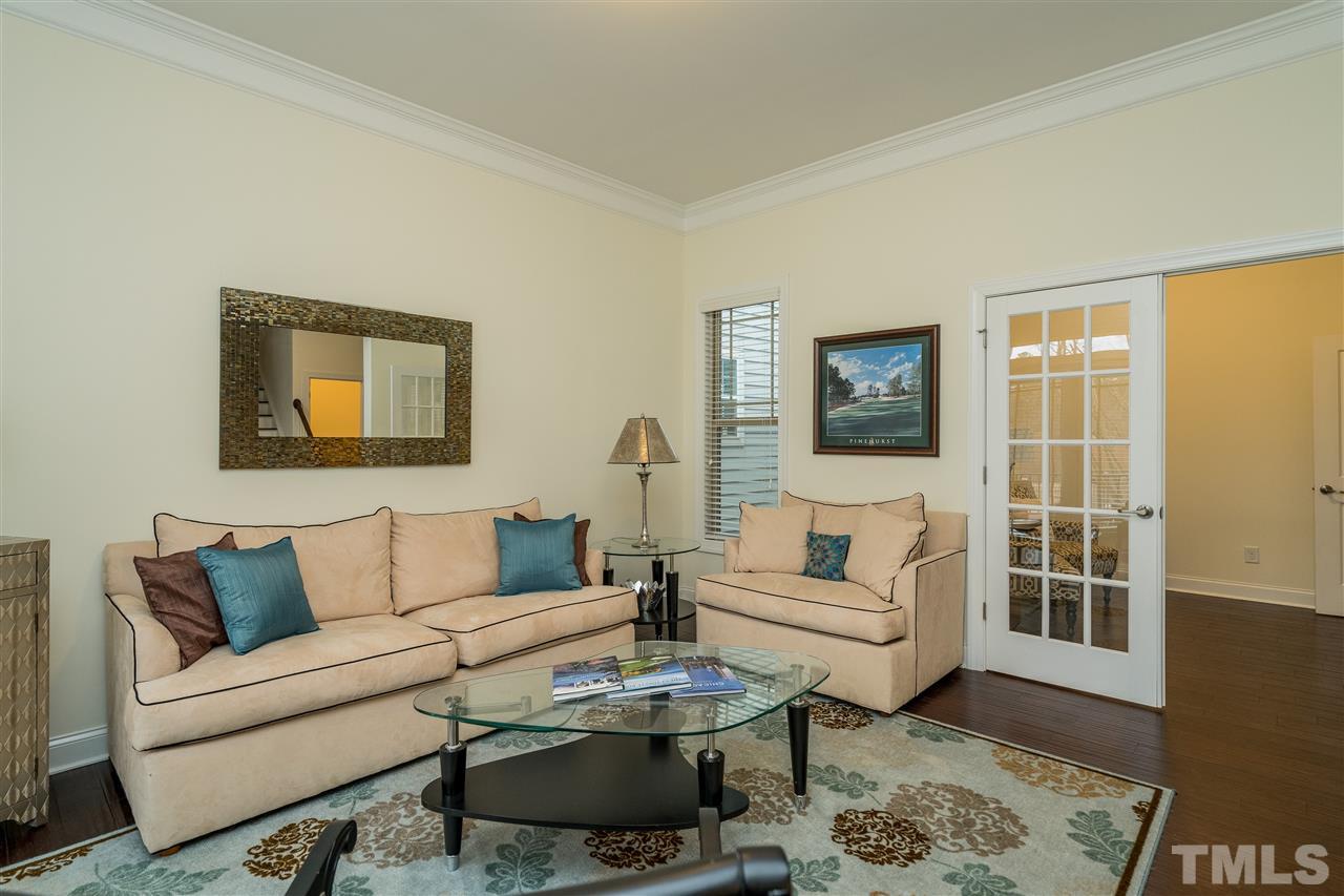 5616 Wade Park Boulevard Raleigh, NC 27607 - Photo 5 of 30 This bright and open living room connects to the office.