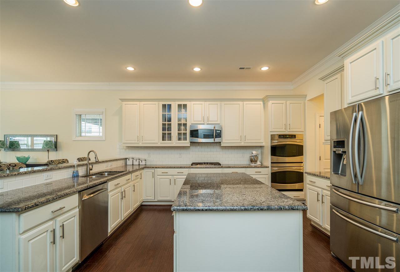 5616 Wade Park Boulevard Raleigh, NC 27607 - Photo 9 of 30 This beautiful kitchen opens up to breakfast room and family room for an open and spacious feel downstairs!
