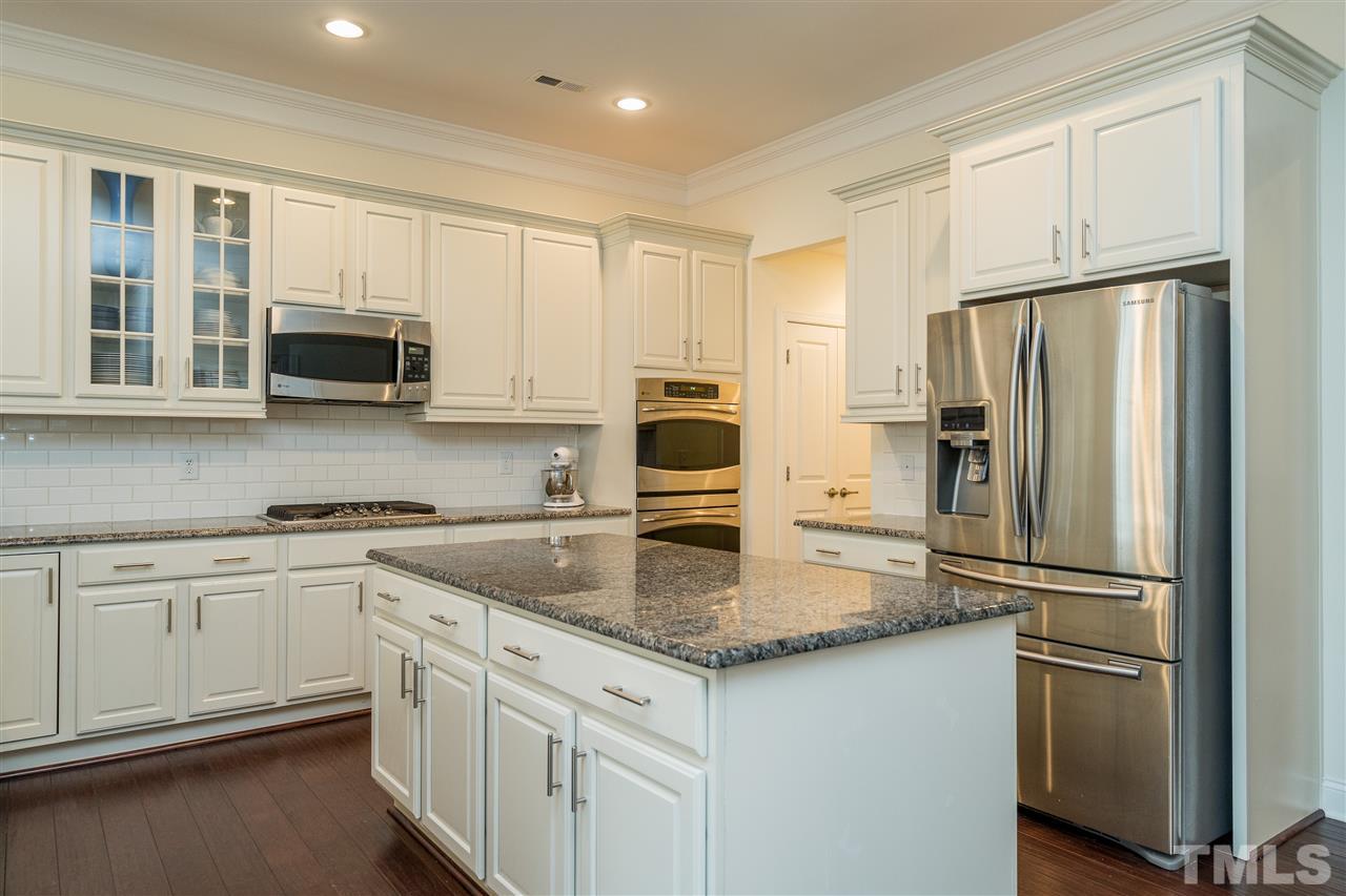 5616 Wade Park Boulevard Raleigh, NC 27607 - Photo 10 of 30 You don't want to miss these beautiful white cabinets with white subway tile backsplash and granite counters!