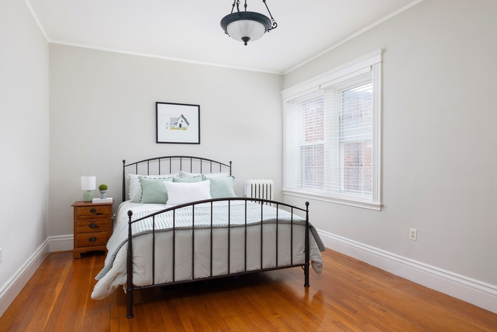 487 Boylston Street, Unit 3 Brookline, MA 02445 - Photo 8 of 14 a bedroom with a bed and wooden floor