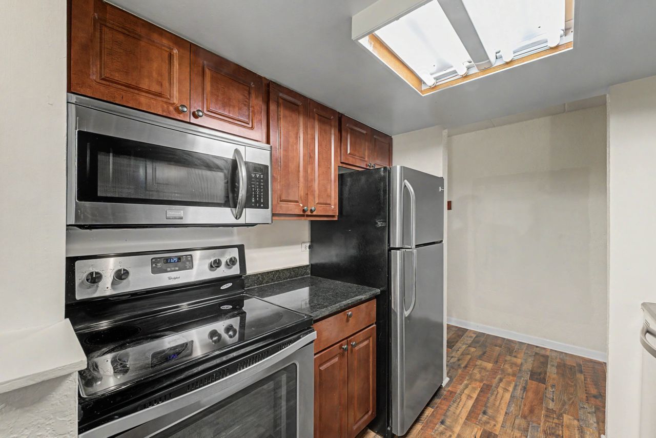 1 Renaissance Place, Unit 1105 Palatine, IL 60067 - Photo 13 of 21 a kitchen with granite countertop a stove microwave and fridge