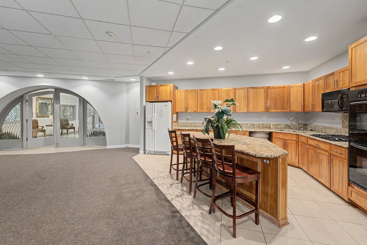 1 Renaissance Place, Unit 1105 Palatine, IL 60067 - Photo 20 of 21 a view of a kitchen with kitchen island granite countertop lots of counter top space and stainless steel appliances