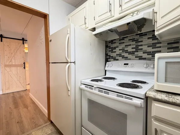 a kitchen with a stove and a refrigerator