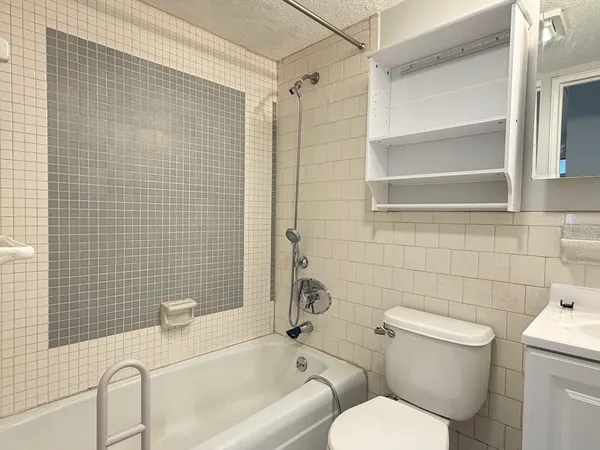 a bathroom with a toilet a sink and bathtub