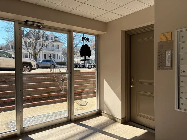 a view of a hallway with a door and balcony
