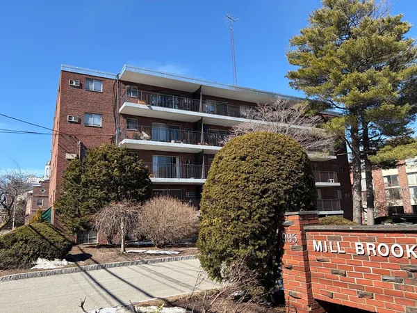 a front view of a building with trees