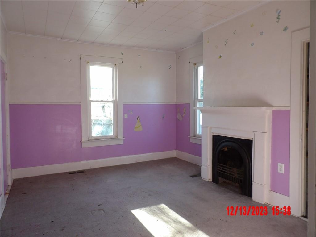 935 Mercer Grove City Road Mercer, PA 16137 - Photo 4 of 17 an empty room with windows and fireplace