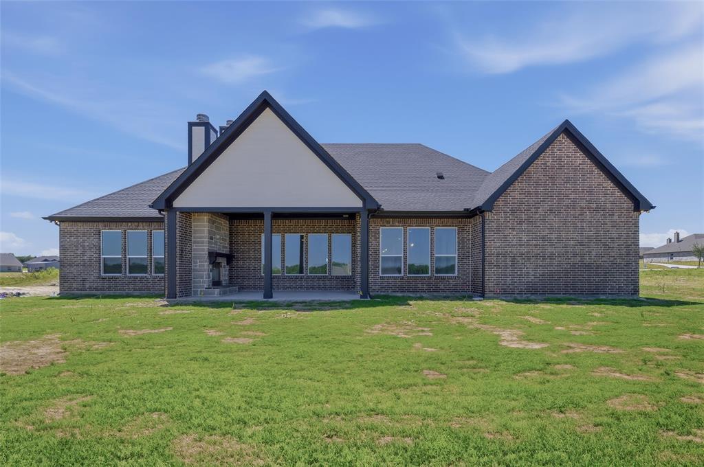 815 Vly Rdg Road Van Alstyne, TX 75495 - Photo 27 of 29 Expansive rear exterior featuring a covered patio with an outdoor fireplace