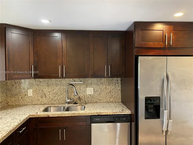 a kitchen with a sink and a refrigerator