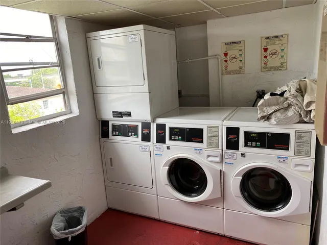 a utility room with dryer washer and a window