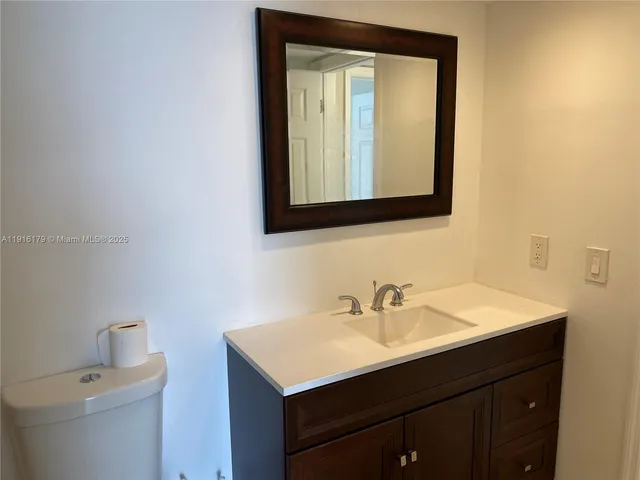 a bathroom with a sink vanity and a mirror